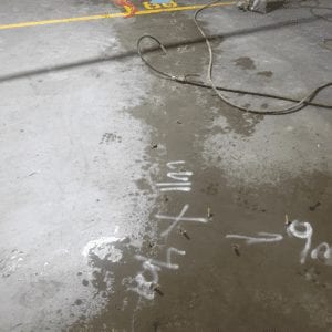 Concrete crack injection repair. High-pressure leak sealing of car park concrete slab.