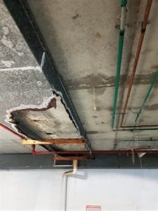 Rusted drip tray and spalling concrete in car park - Waterstop Solutions