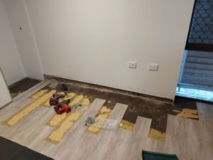 Vinyl flooring removed for access before leak sealing injection - Waterstop Solutions