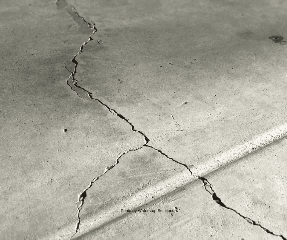 Cracked concrete slab in garage - Photo by Waterstop Solutions
