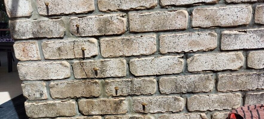 Cracks in NIB brick wall during epoxy injection by Waterstop Solutions